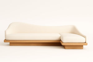 Sculptural Custom Chrissie Sofa with ivory boucle upholstery and natural oak plinth, featuring a wavy silhouette.